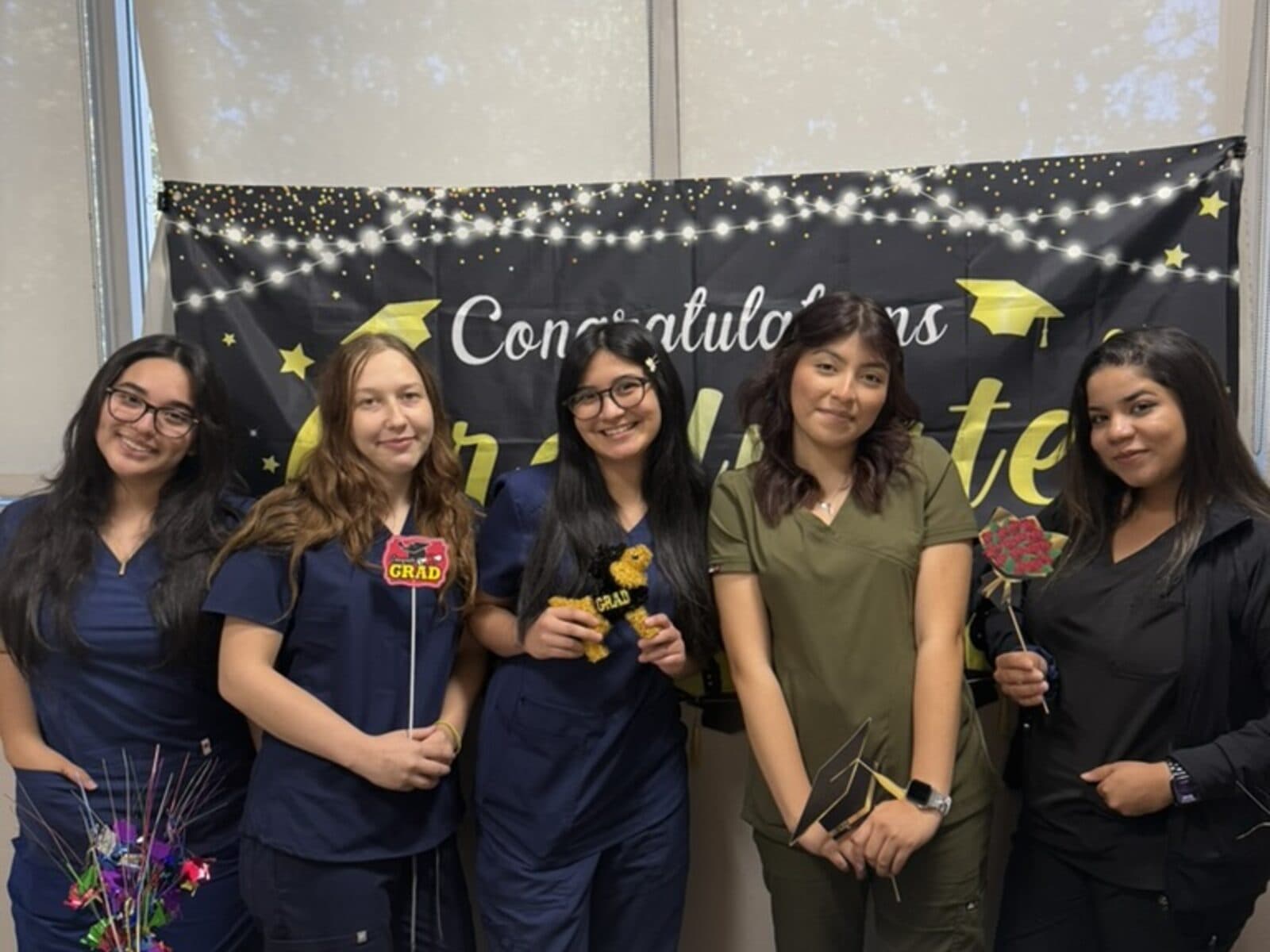 Recent Roseville Dental Academy students celebrating certificates indoors