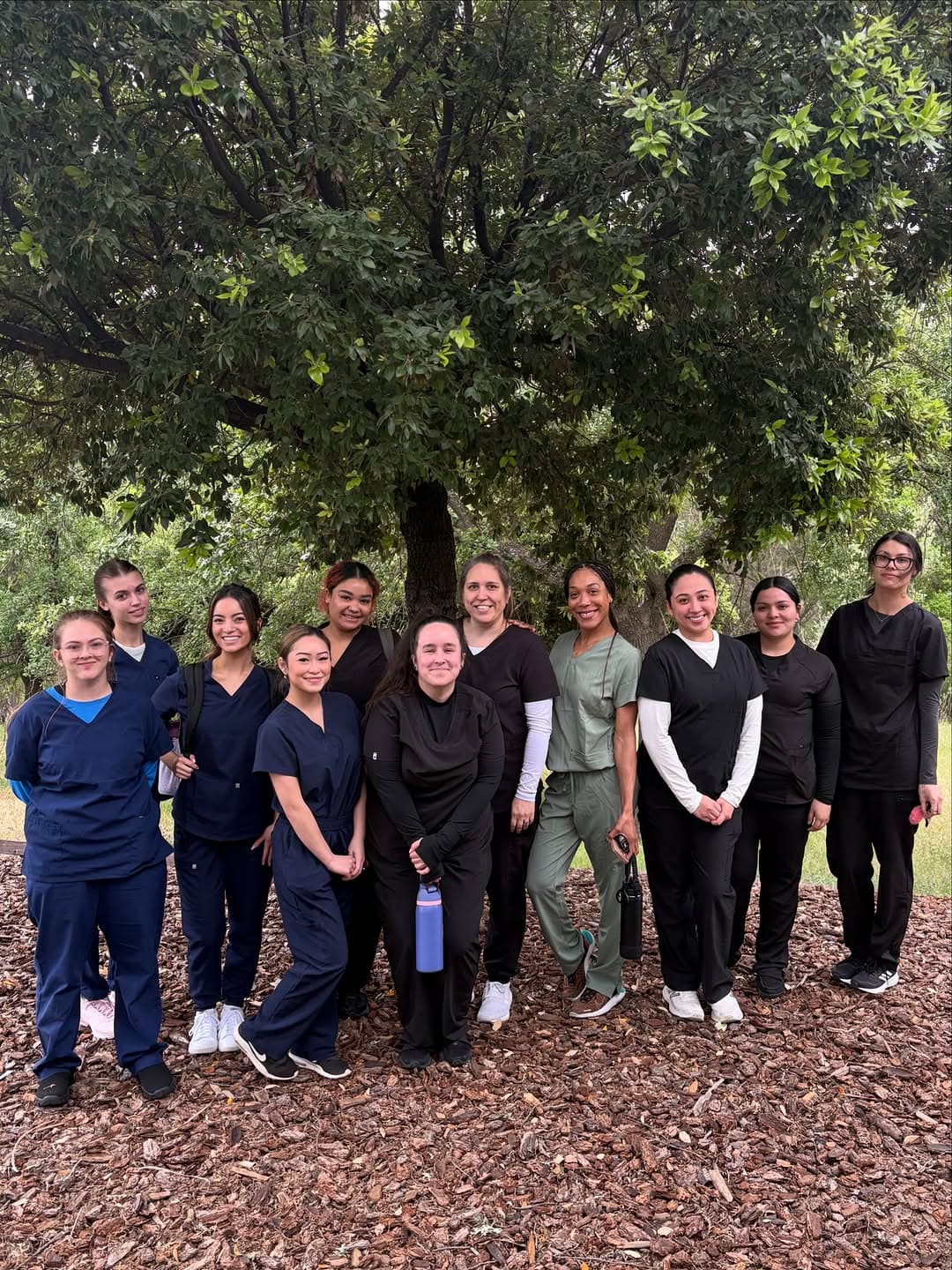 Roseville Dental Academy dental assisting students gathered outdoors in scrubs.