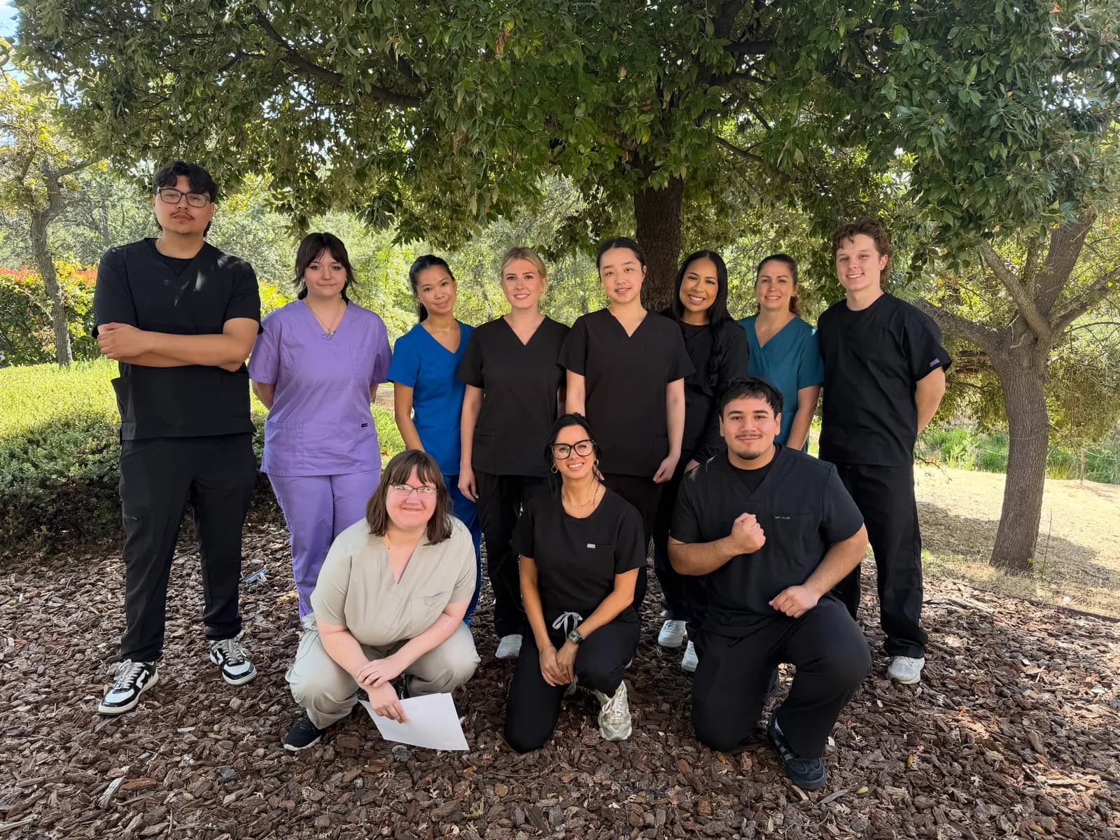 A new Roseville Dental Academy dental assisting class gathered outdoors in scrubs.