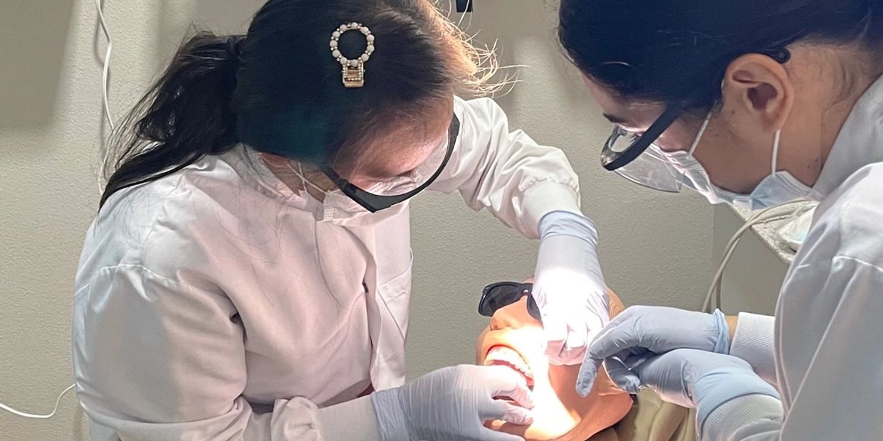 Roseville Dental Academy student practicing coronal polish technique with instructor guidance.