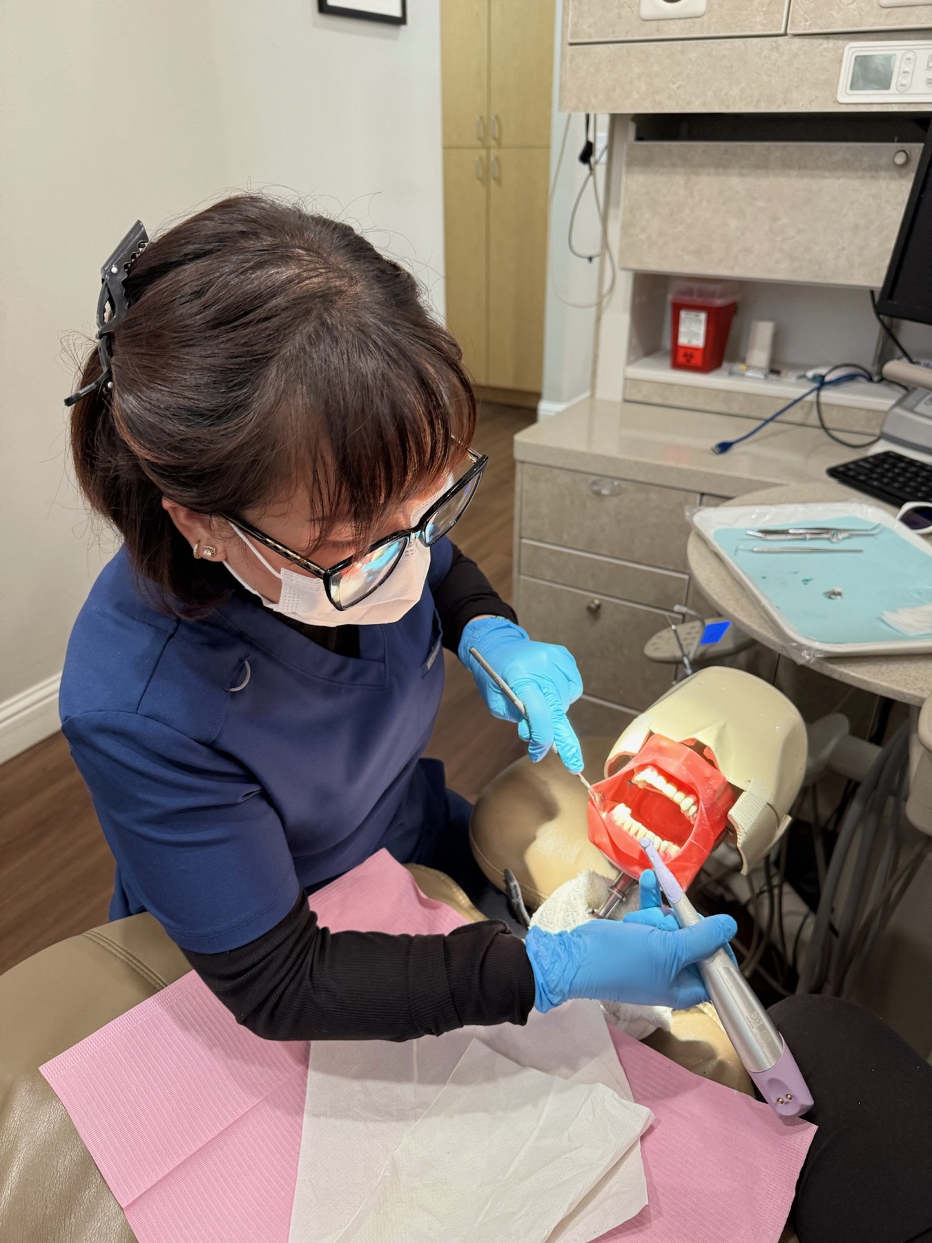 Roseville Dental Academy student practicing coronal polish technique on a typodont.