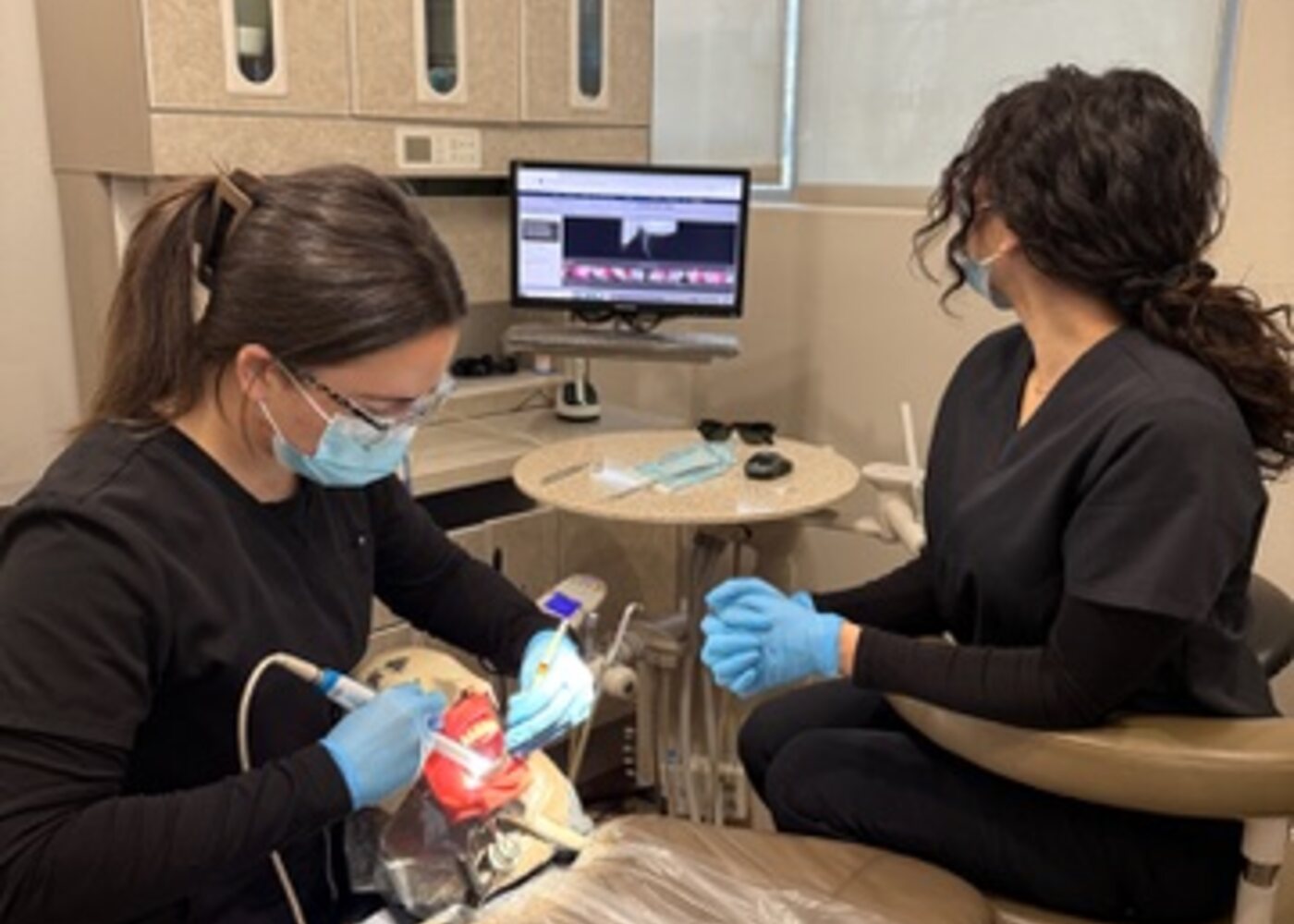 Roseville Dental Academy students reviewing dental x-ray imaging during radiation safety training.