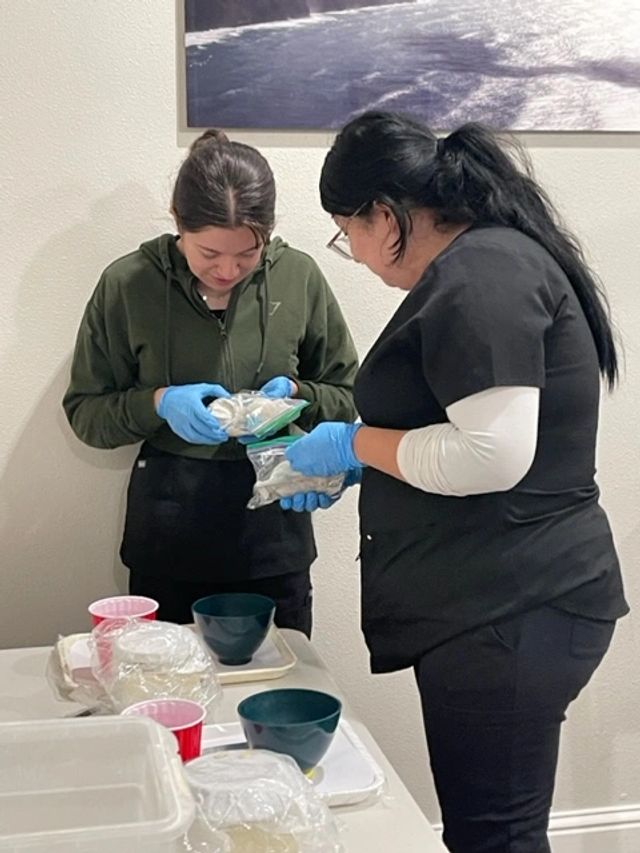 Student preparing dental materials during coronal polish training.