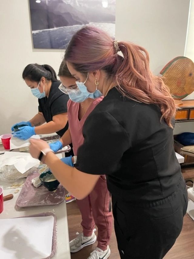 Students practicing hands-on dental technique during coronal polish lab work.